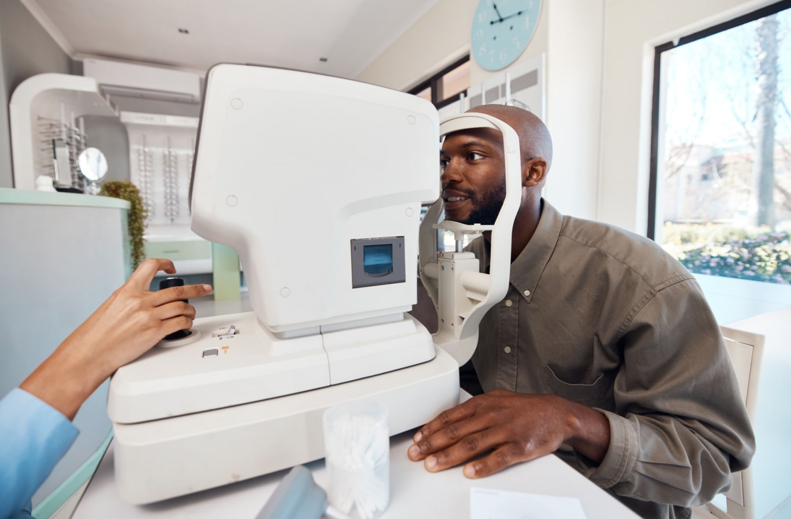 A man getting his eyes checked for contact lens compatibility.